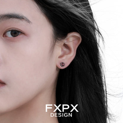 Punk crystal stud earrings showcased on model with dark hair for a trendy look