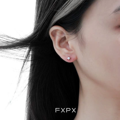 Radiant star silver stud earrings showcased on a model's ear for a sparkling look