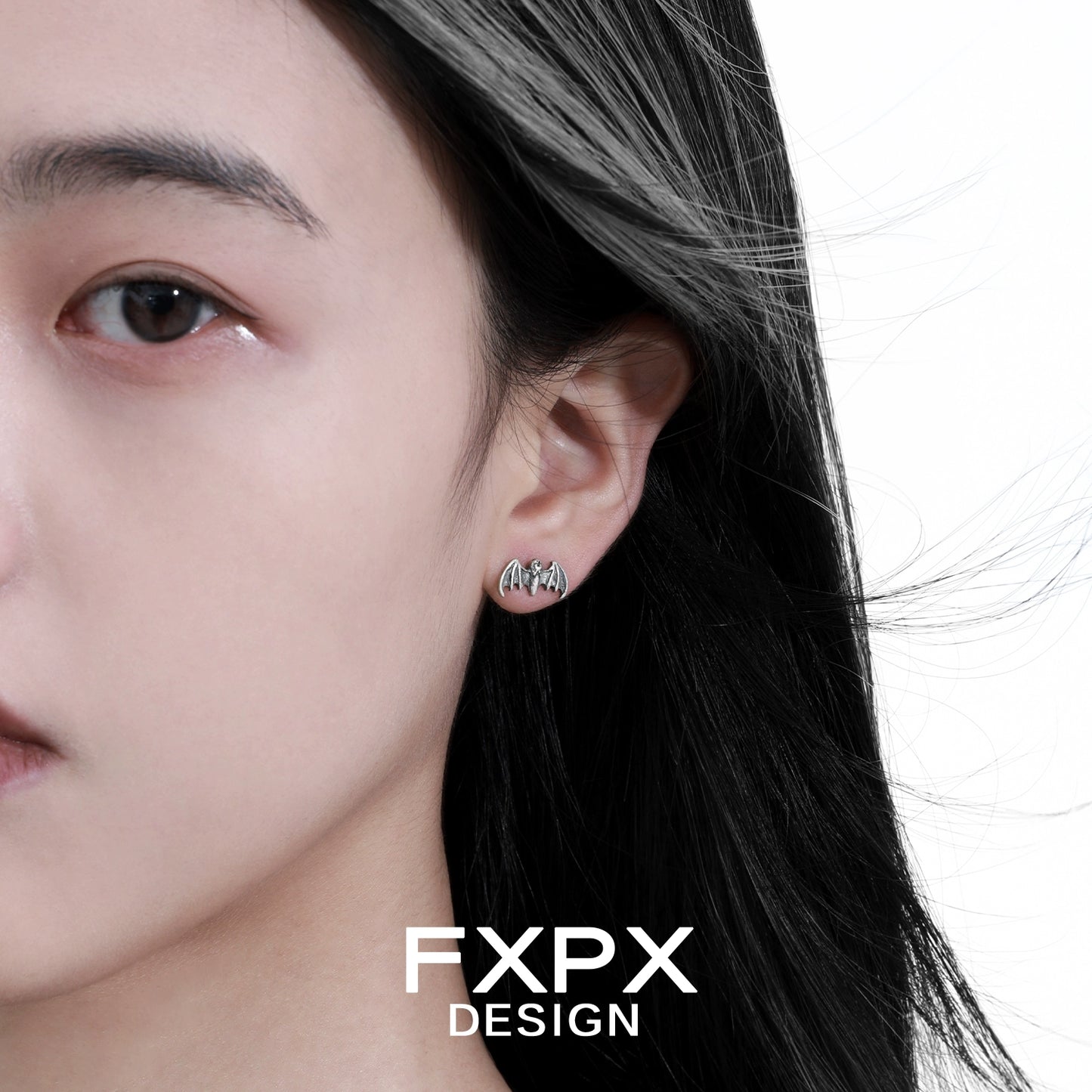 FXPX retro bat stud earrings worn by a model with flowing hair for a stylish look