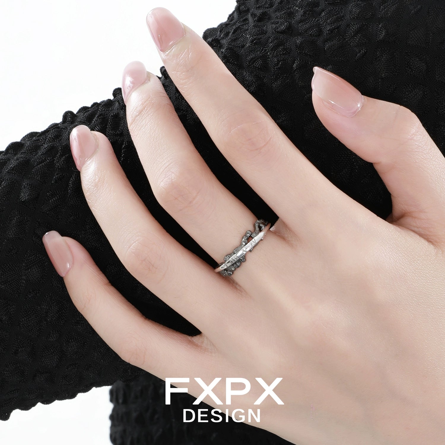 Elegant FXPX roman numeral couple rings displayed on a model's hand for meaningful connections