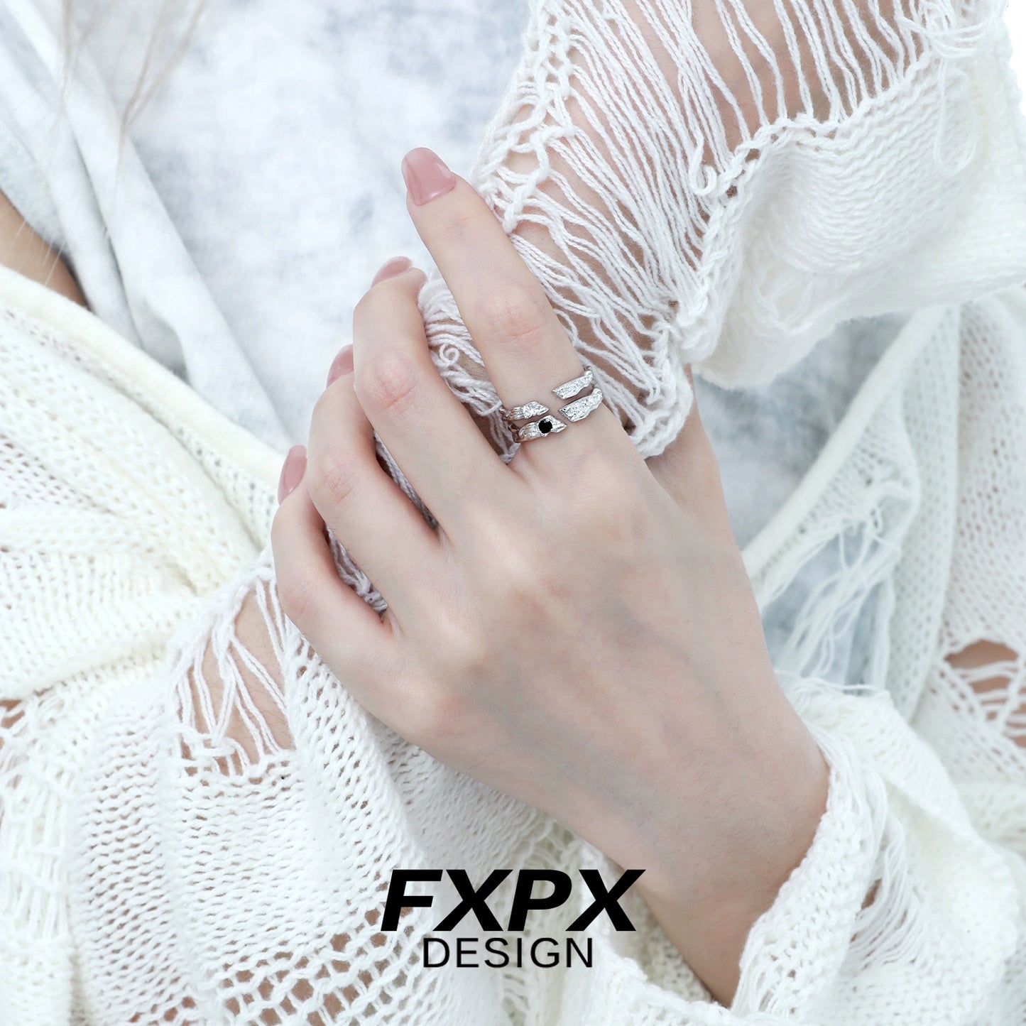 Stylish FXPX secret bond couple rings showcased on a hand with a textured sweater