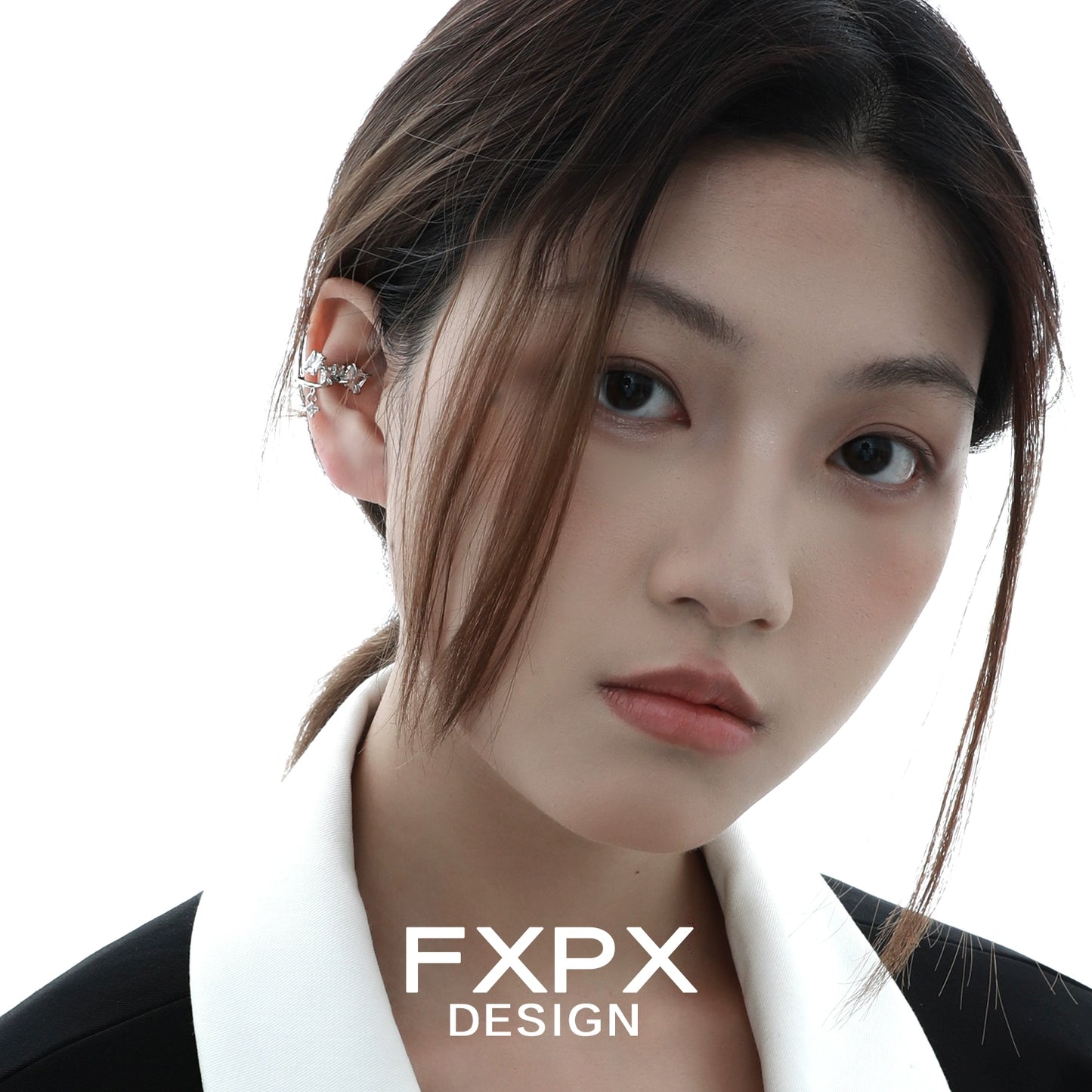 Model wearing FXPX shattered prism zircon ear cuff, showcasing a modern and elegant design