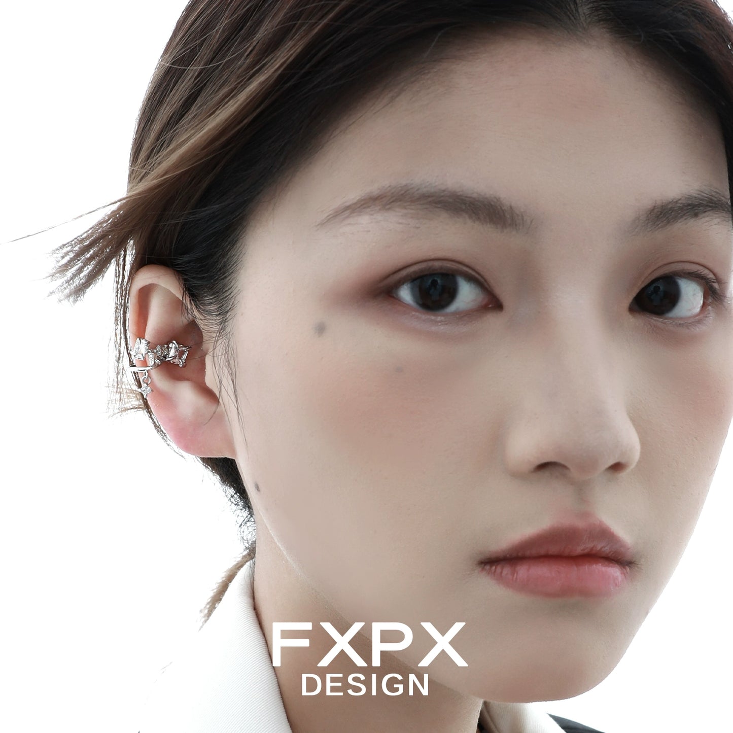 Model wearing shattered prism zircon ear cuff showcasing stylish and modern design