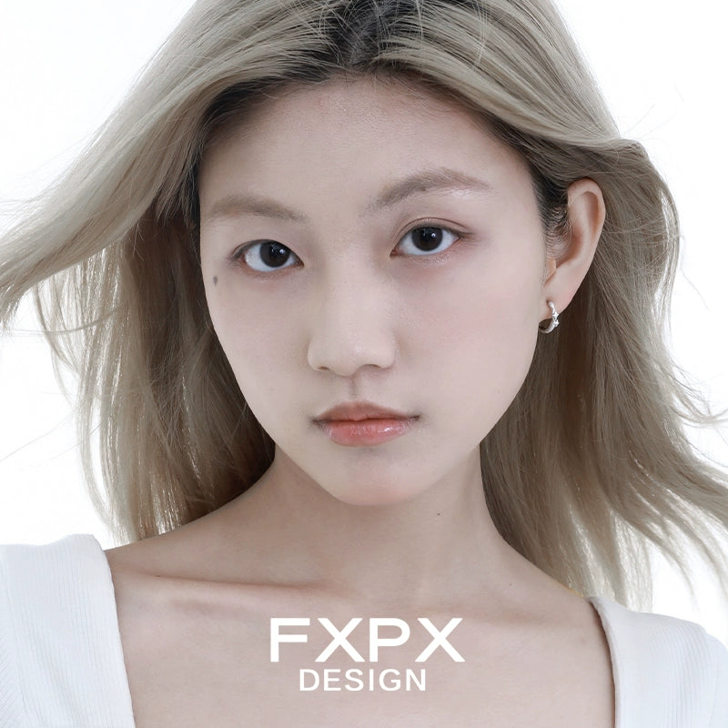 Model wearing FXPX shattered star silver earrings, showcasing modern and elegant design