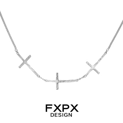 FXPX silver cross necklace featuring three textured crosses on a delicate chain