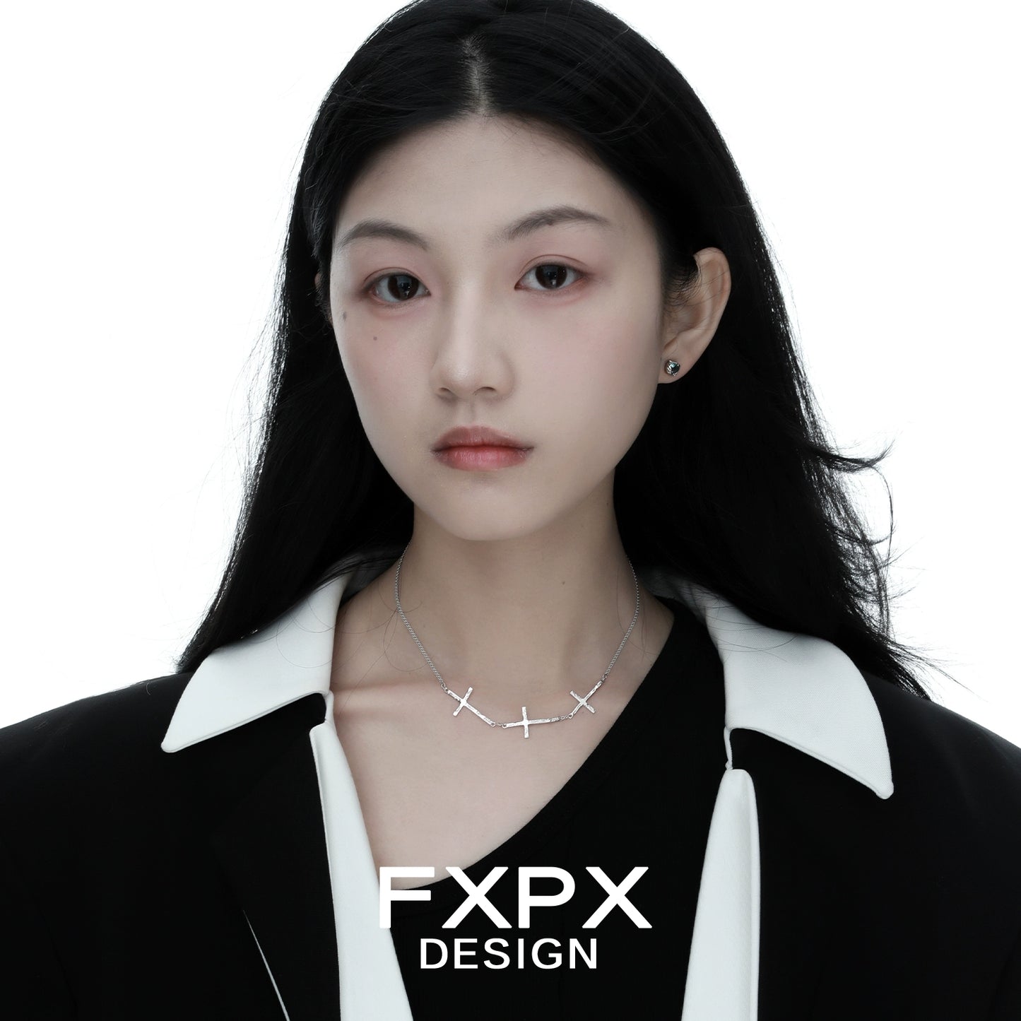 Elegant FXPX silver cross necklace worn by model against white background