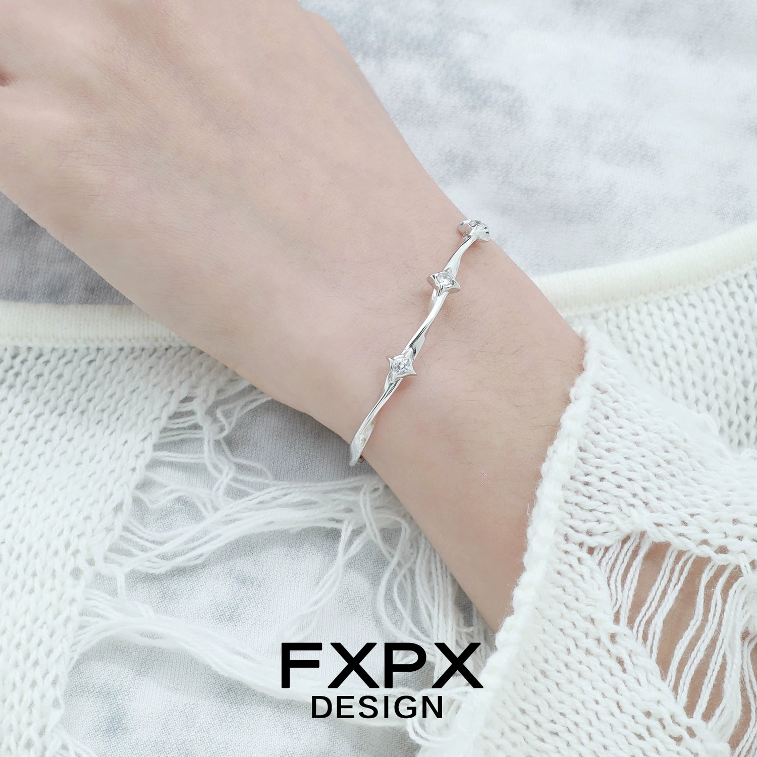 Elegant FXPX silver star bracelet worn on wrist for a stylish touch