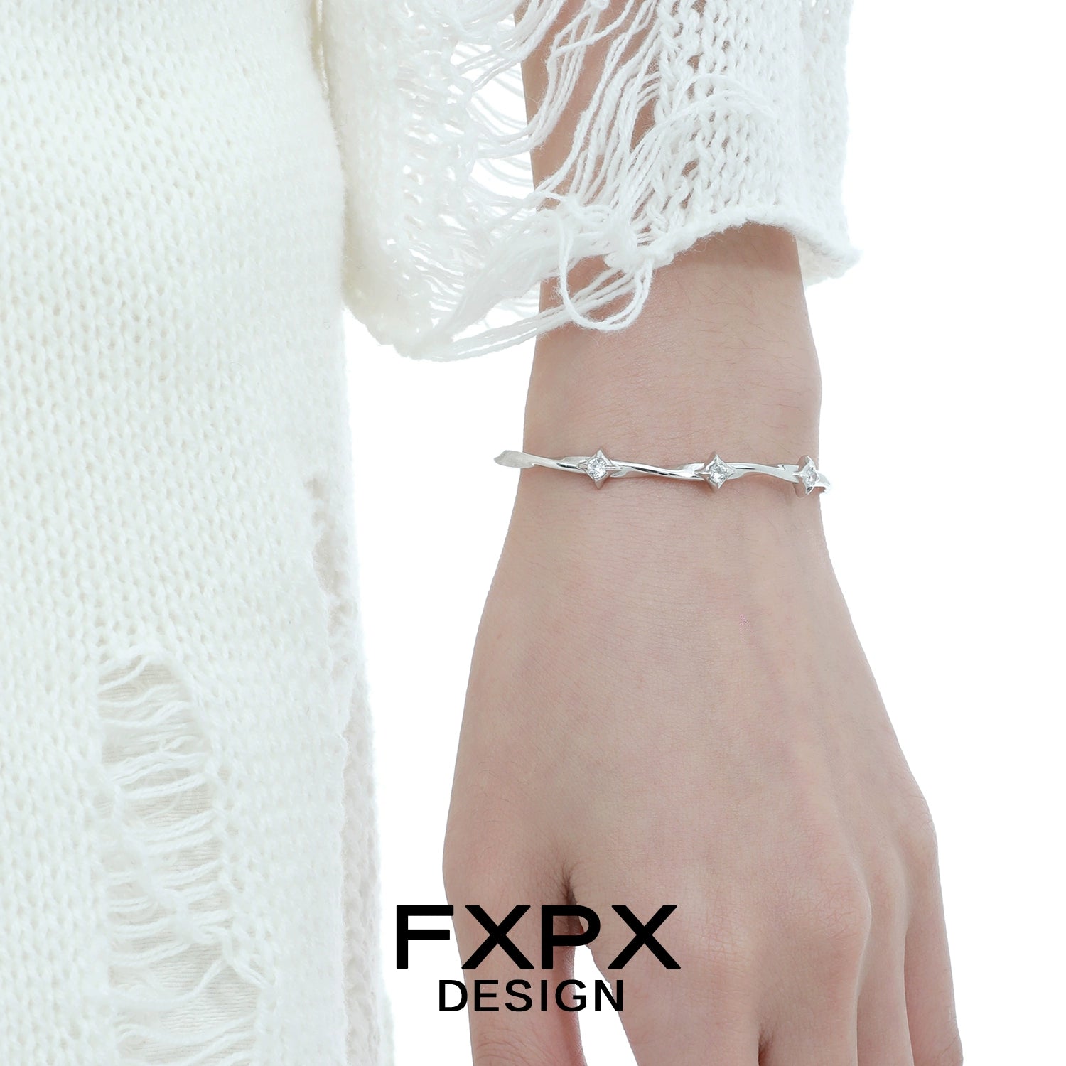 Stylish FXPX silver star bracelet on a wrist, perfect for elegant and casual outfits