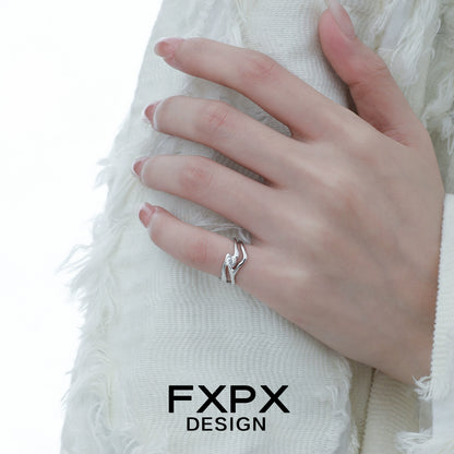 Stylish FXPX silver wave zircon ring displayed on a hand with textured white fabric background