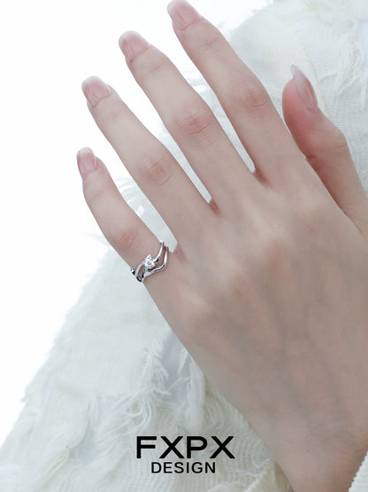 Elegant FXPX silver wave zircon ring displayed on a model's hand with a delicate design