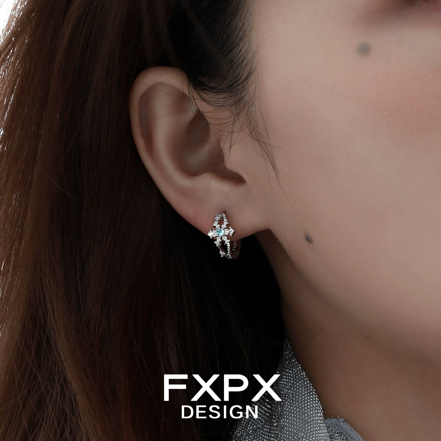 Elegant FXPX snowflake cross earrings featuring intricate details and a sparkling design