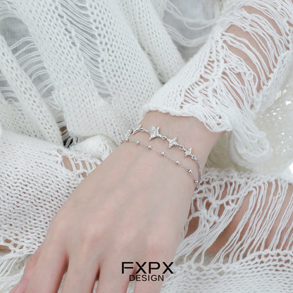 Elegant FXPX star silver bracelet featuring delicate star and bead accents for a stylish look