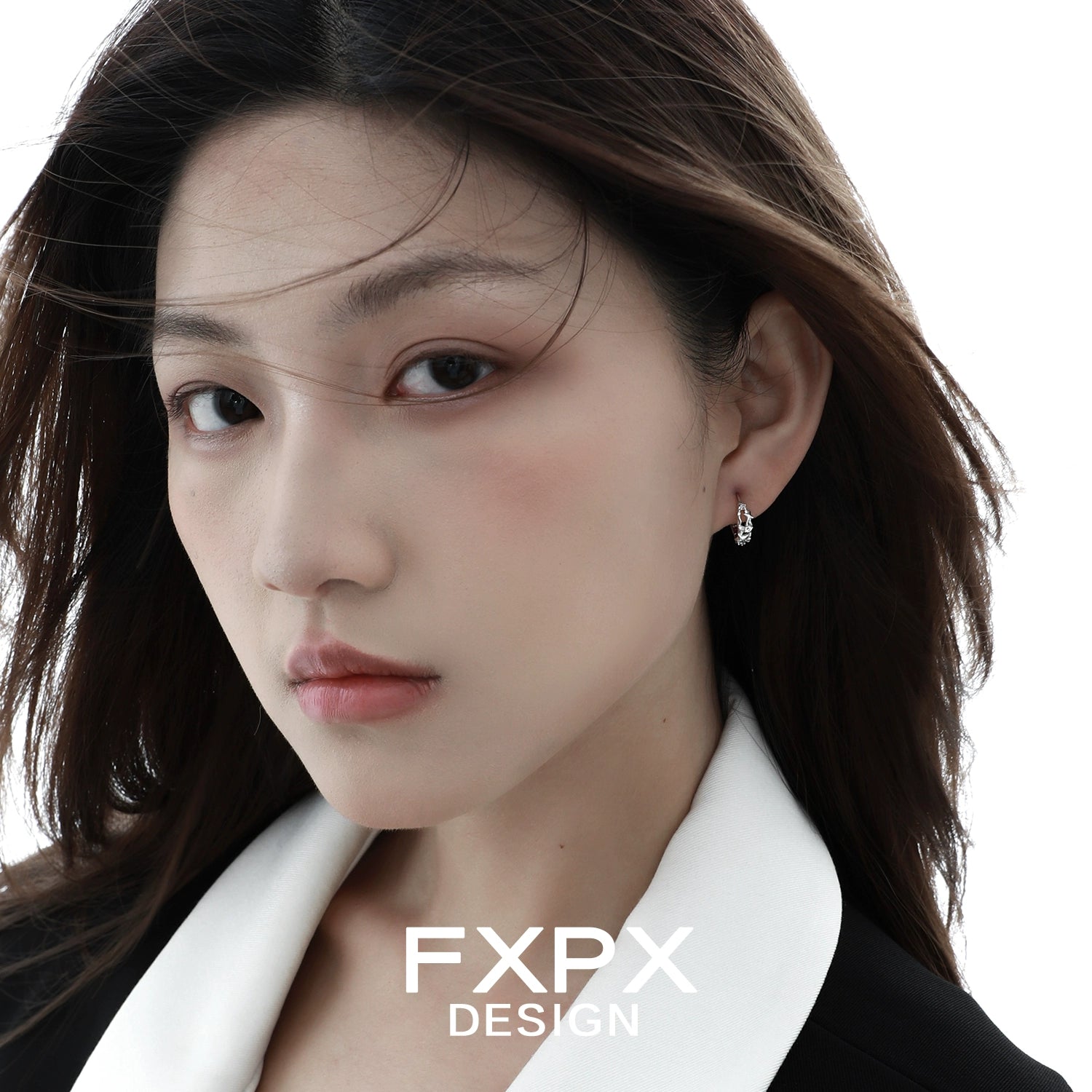 Model wearing FXPX star silver earrings, featuring a unique star design and elegant finish