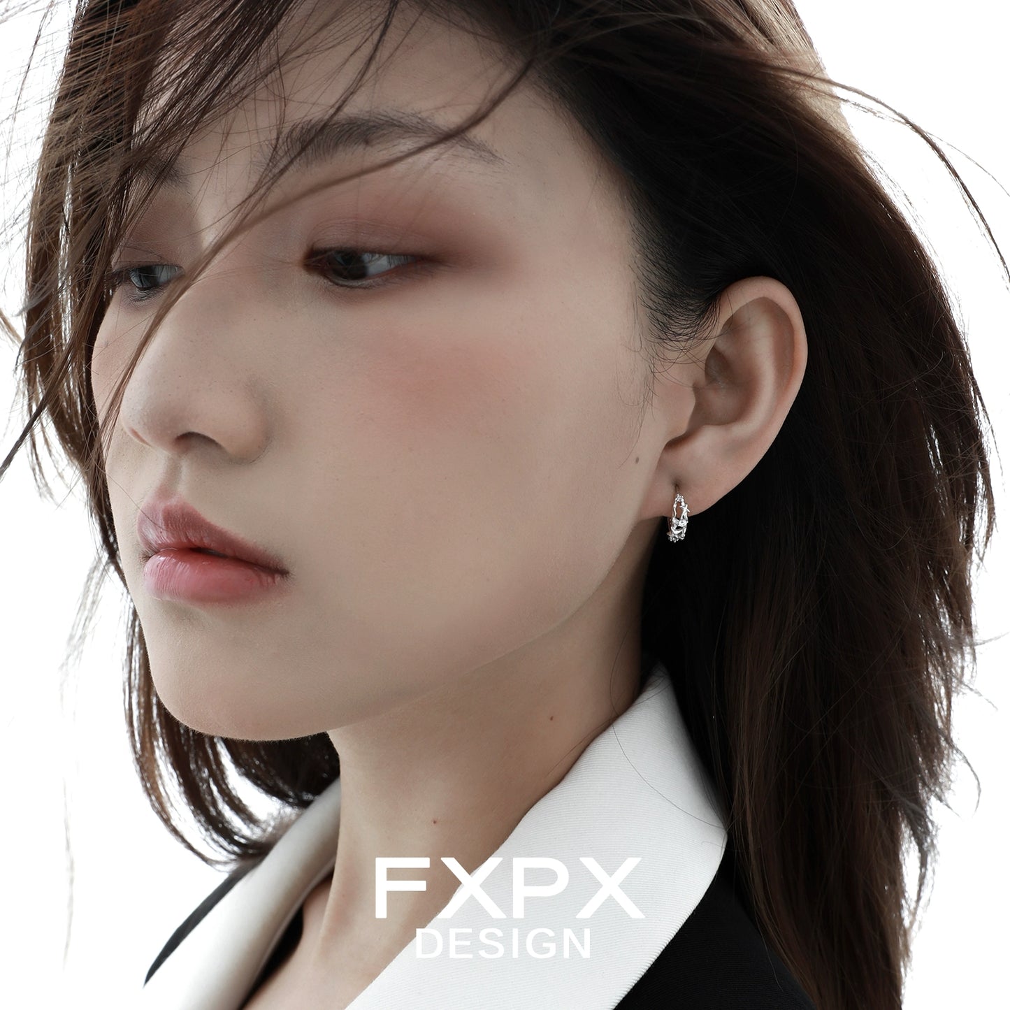 Elegant star silver earrings showcased on a model with soft makeup and flowing hair