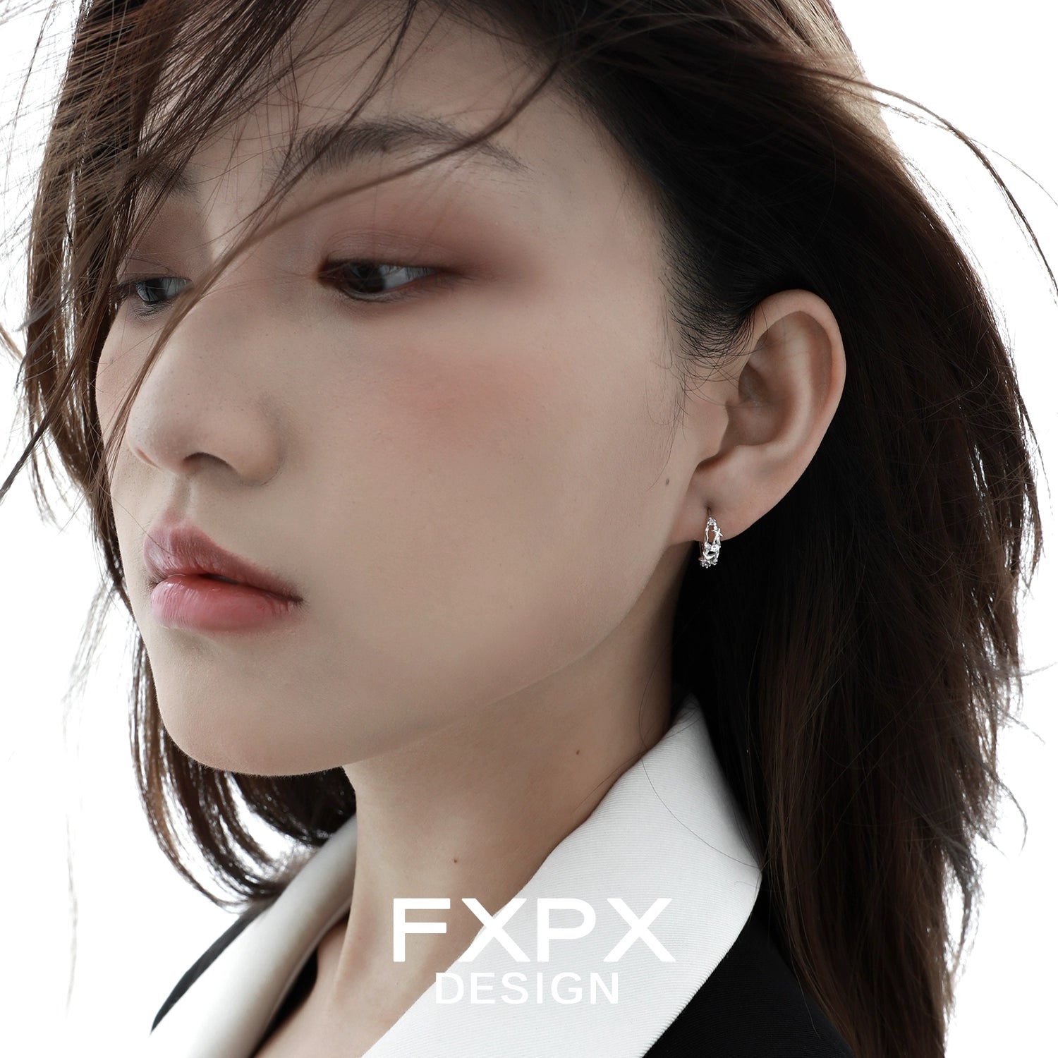 Elegant star silver earrings showcased on a model with soft makeup and flowing hair