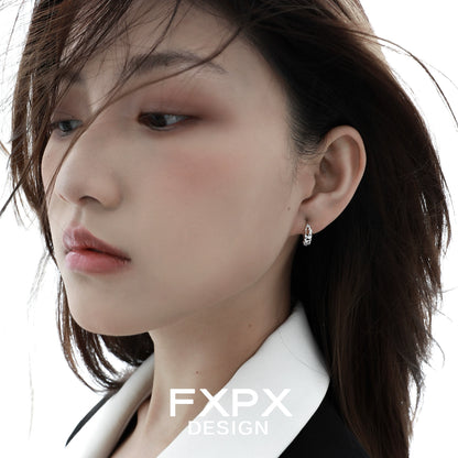 Elegant star silver earrings showcased on a model with soft makeup and flowing hair