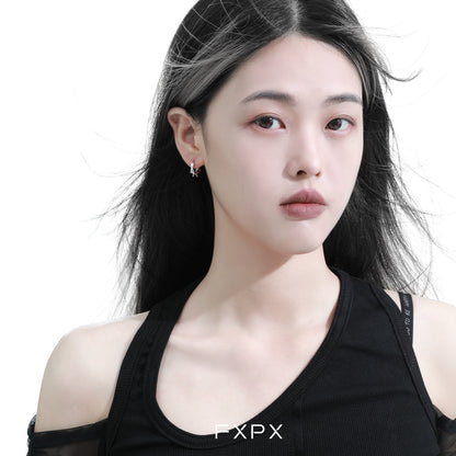 Stylish thorn silver hoop earrings worn by a model showcasing contemporary fashion