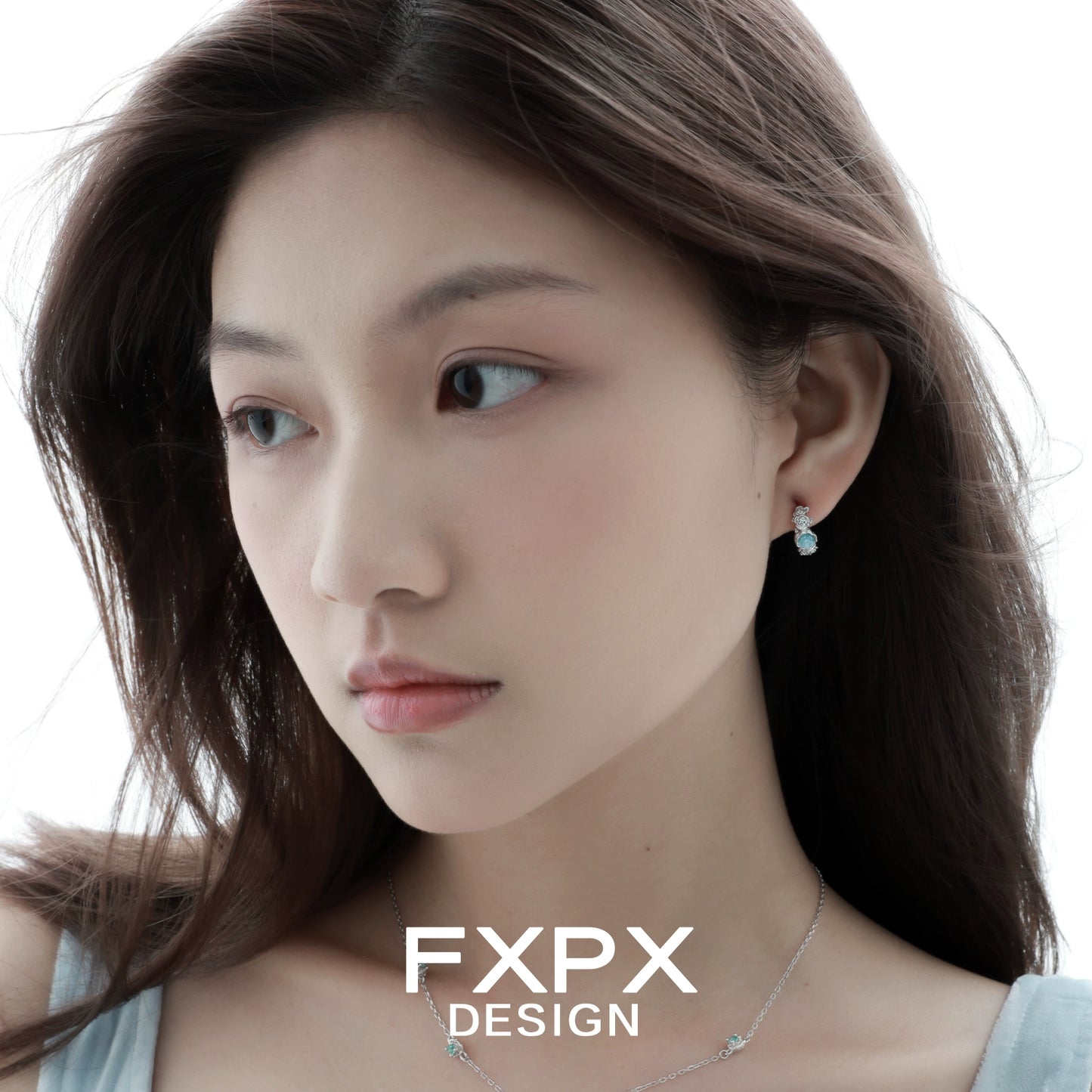 Elegant vintage blue rose earrings showcased on a model with flowing hair