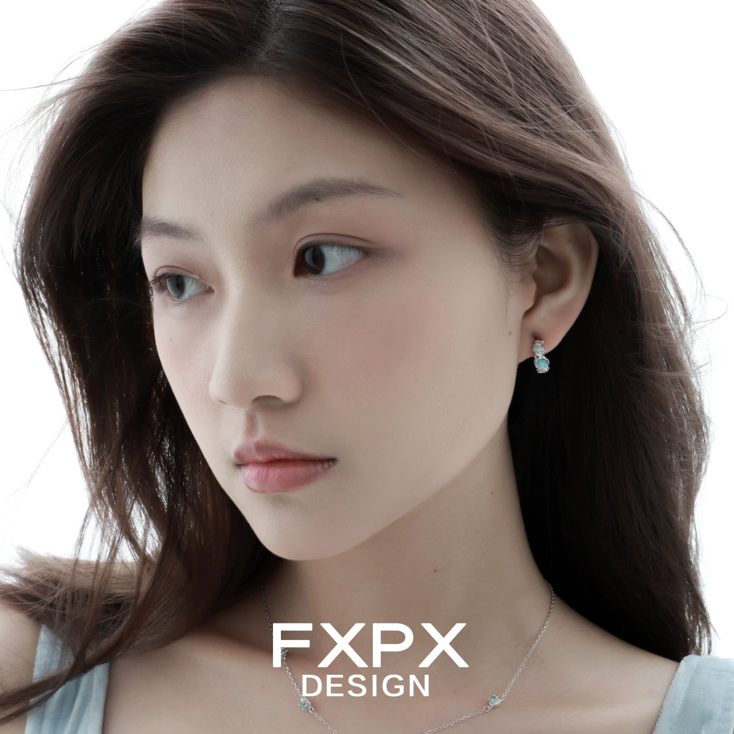Elegant vintage blue rose earrings showcased on a model with flowing hair