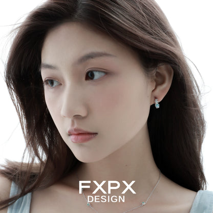 Elegant vintage blue rose earrings showcased on a model with flowing hair