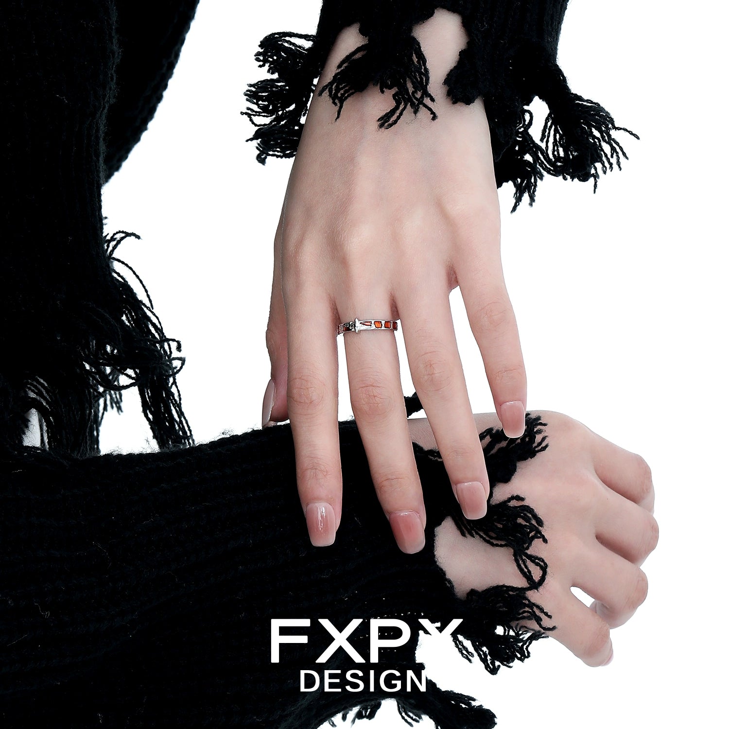 Stylish vintage checkerboard star ring showcased on a model's hand with black fringed sweater
