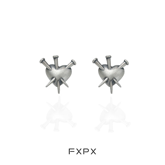 Vintage punk silver earrings featuring a heart design with spikes for a bold fashion statement