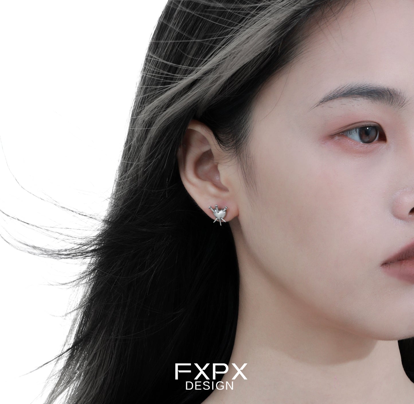 Close-up of vintage punk silver earrings worn by a model showcasing edgy style and unique design