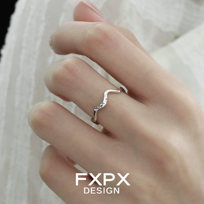 Elegant wavy silver ring by FXPX shown on a woman's hand for stylish accessorizing