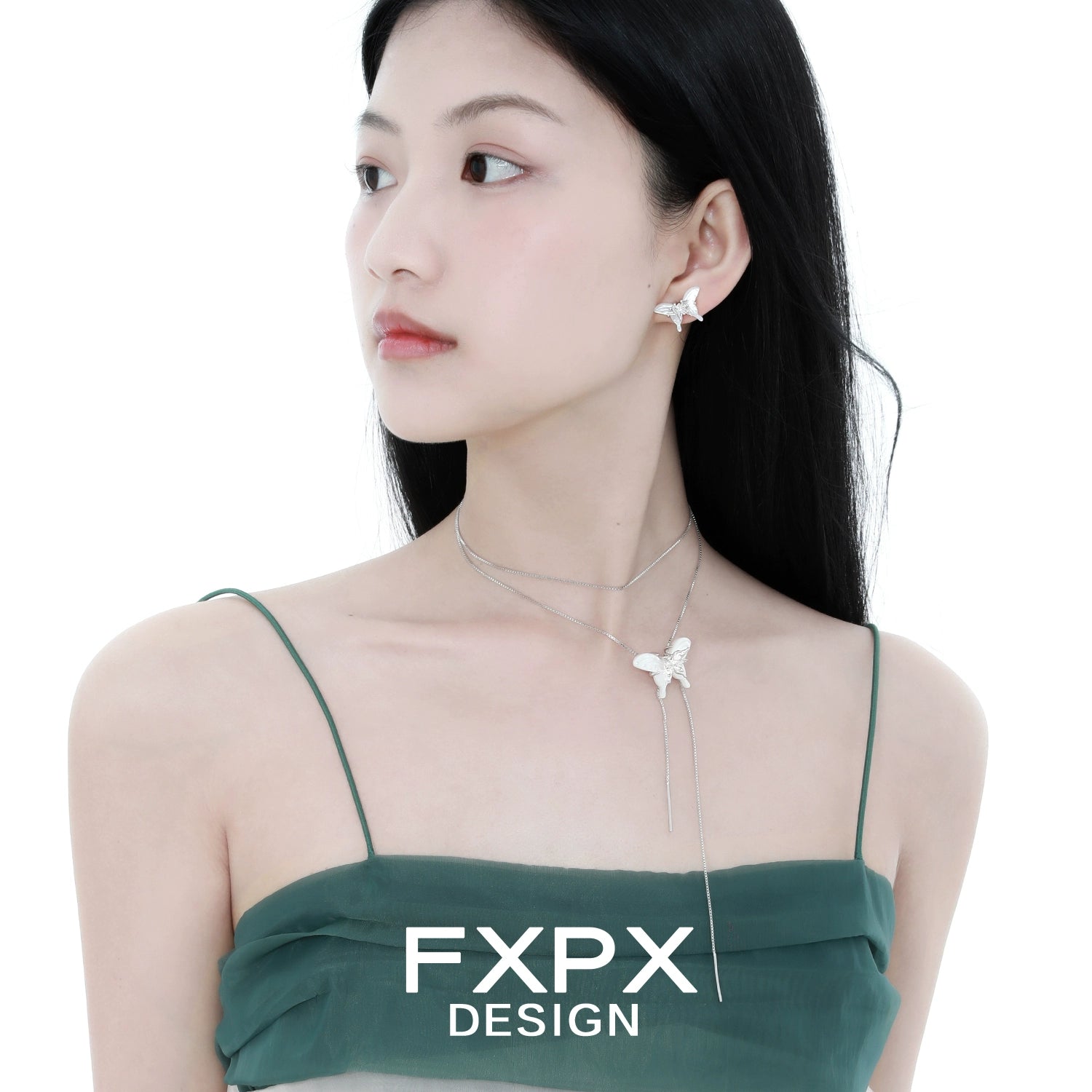 Elegant white shell butterfly earrings by FXPX worn by a model with a stylish outfit
