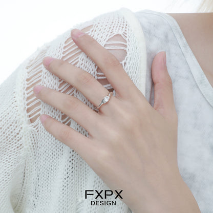 Elegant FXPX white zircon ring with a delicate twisted design on a model's hand