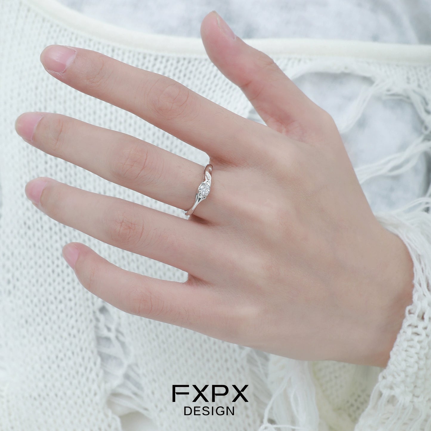 Elegant FXPX white zircon ring displayed on a woman's hand, showcasing intricate design and sparkle