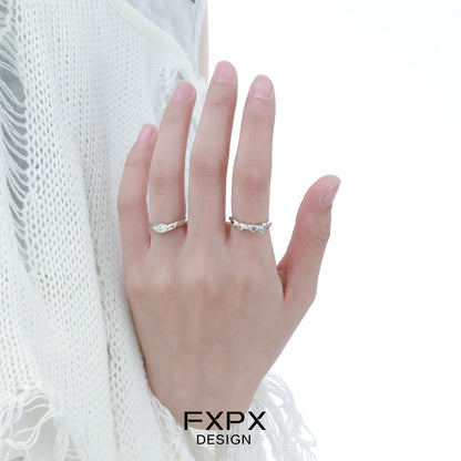 Elegant FXPX white zircon ring displayed on a hand with a soft knit background