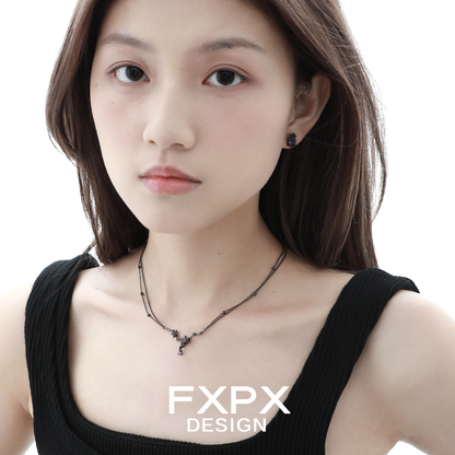 FXPX Y2K blue rose earrings showcased on a model with a stylish black top