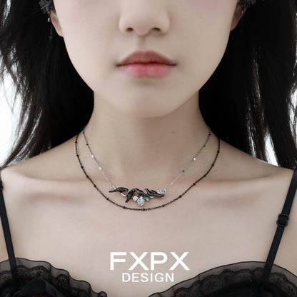 Y2K crow pendant necklace by FXPX showcased on a model with a chic outfit