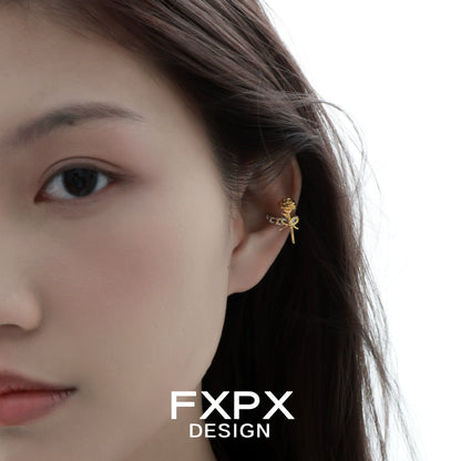 Y2K golden rose ear cuff worn stylishly on a model's ear showcasing its unique design