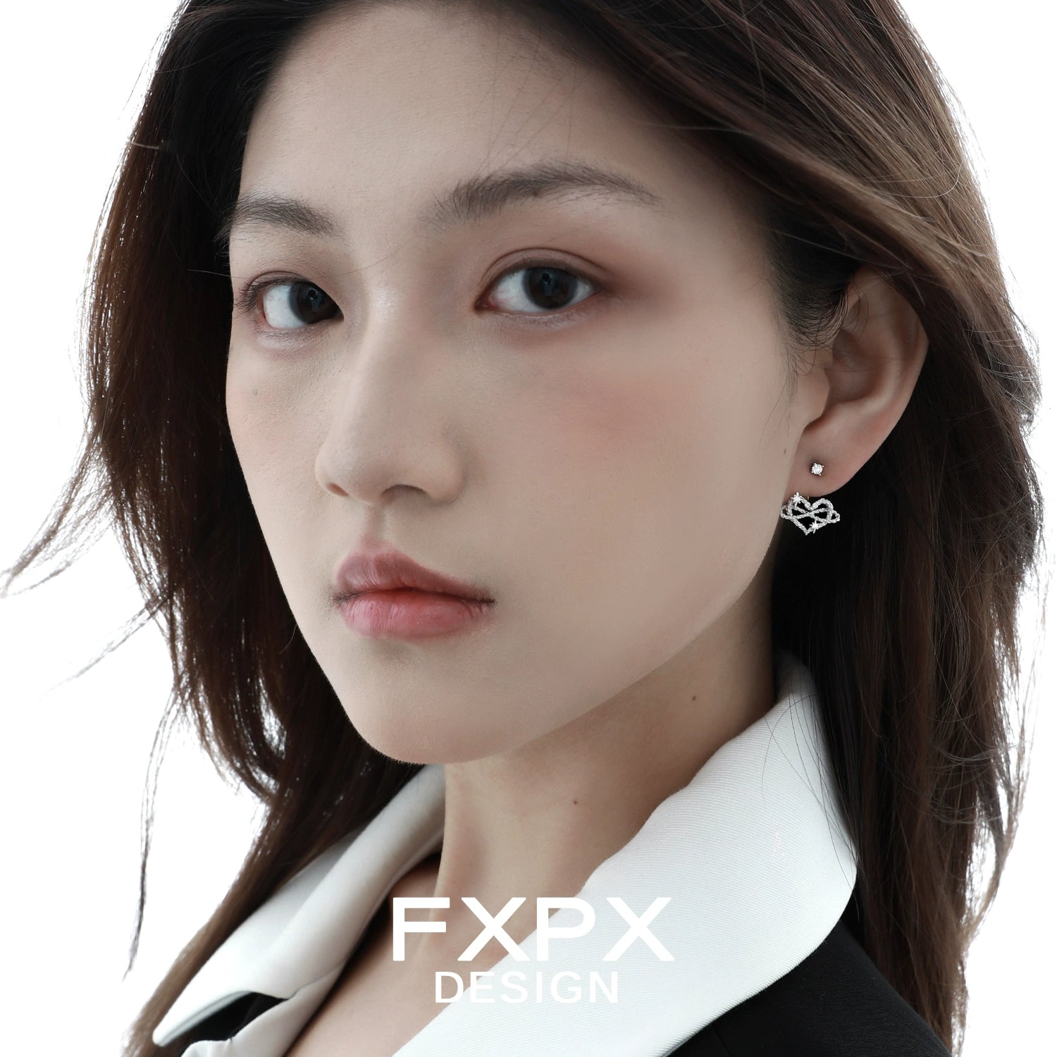 FXPX Y2K heart earrings in silver worn by a model with a chic hairstyle