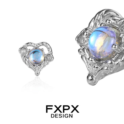 FXPX Y2K moonstone earrings in silver with intricate design and a glowing opalescent stone