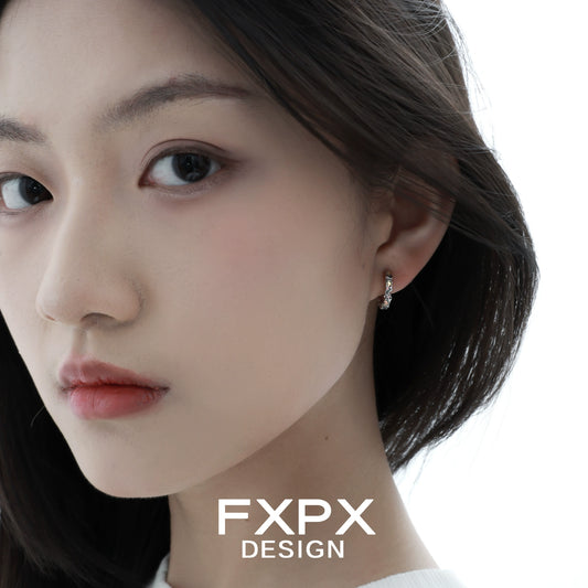 Close-up of a model wearing Y2K prism glow earrings for a trendy fashion statement