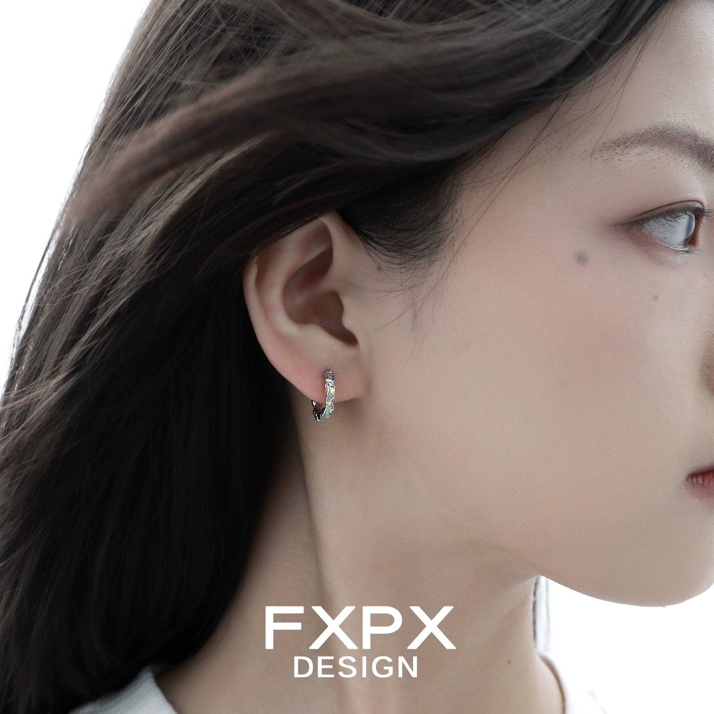 Elegant Y2K prism glow earrings showcased on model's ear with soft lighting