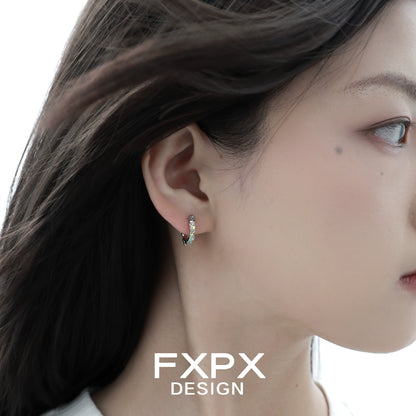 Elegant Y2K prism glow earrings showcased on model's ear with soft lighting