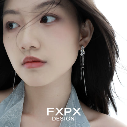 Y2K silver tassel earrings hanging elegantly on a model with flowing hair