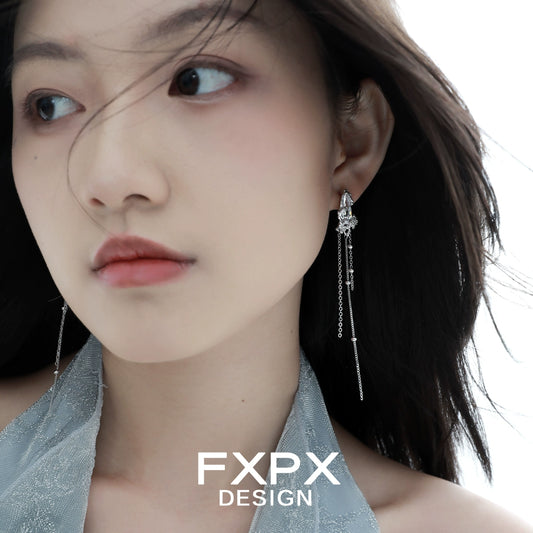 Y2K silver tassel earrings hanging elegantly on a model with flowing hair