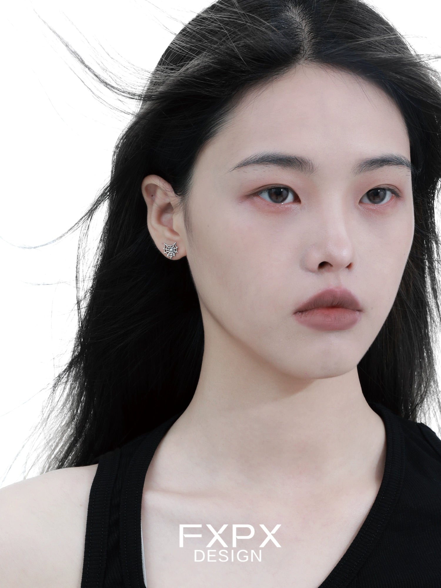 FXPX Y2K spider web earrings showcased on a model with flowing hair and a neutral expression