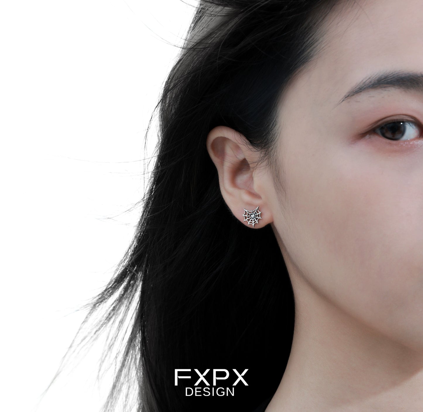 FXPX Y2K spider web earrings showcased on a model's ear with flowing hair