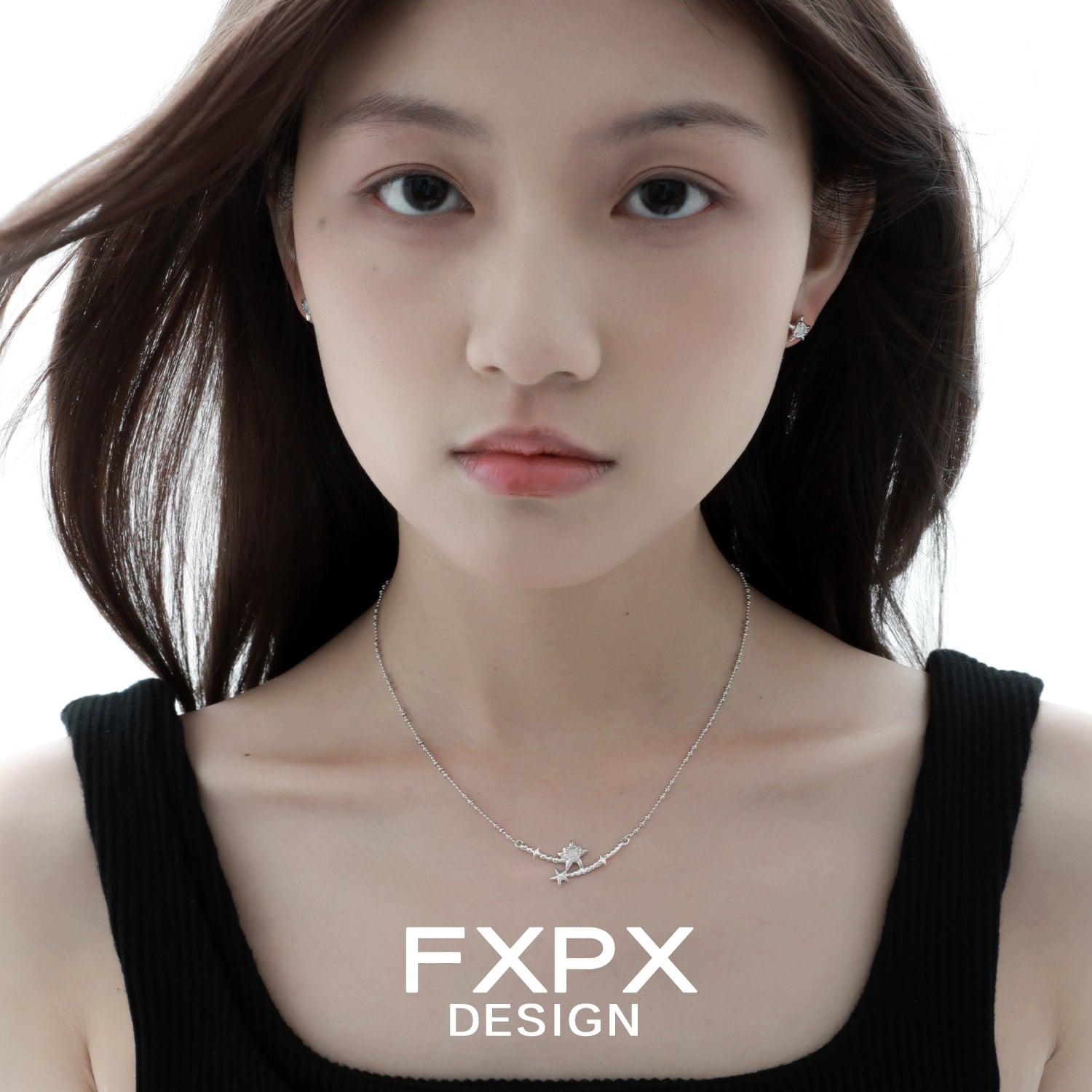 Close-up of a model wearing FXPX Y2K starfish earrings with a silver necklace for a trendy beach vibe