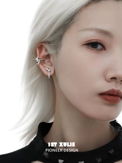 Stylish galactic star geometric earrings showcased on a model with silver hair