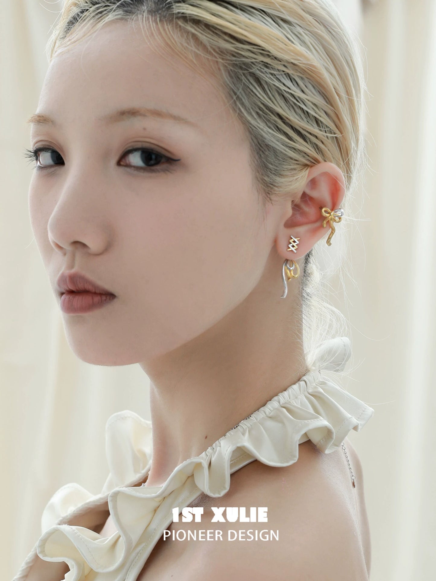 Elegant gold bow ear cuff designed by 1ST XULIE, enhancing the ear with unique style