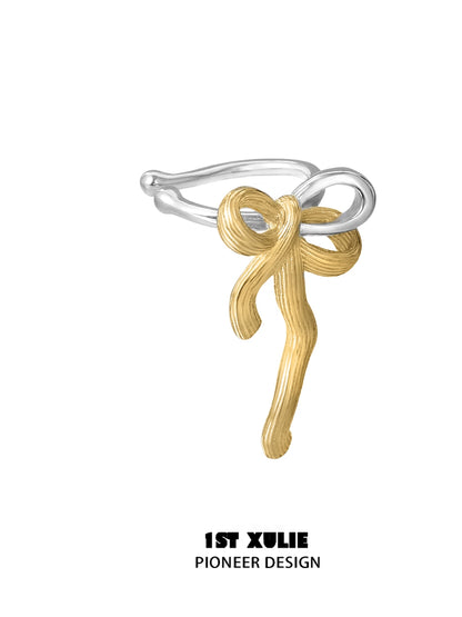 Gold bow ear cuff by 1ST XULIE with a unique twisted design for stylish ear jewelry