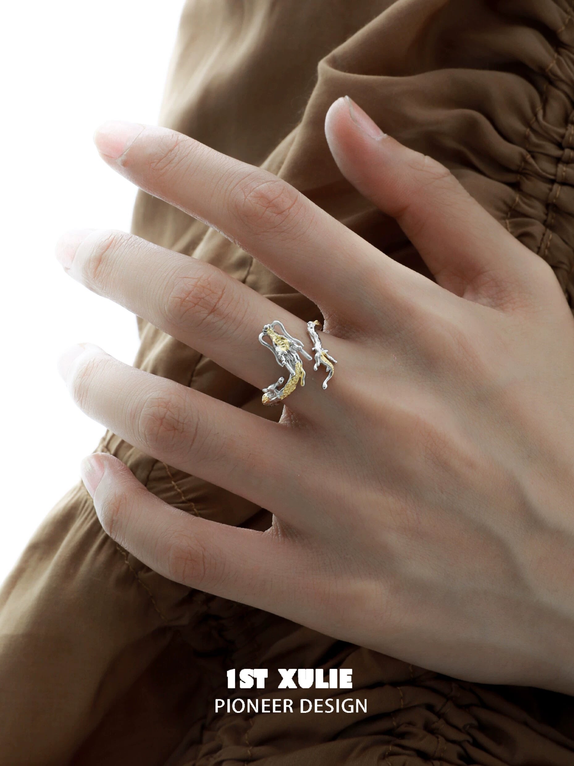 Gold dragon wrap silver ring on a model's hand, showcasing a unique and elegant design