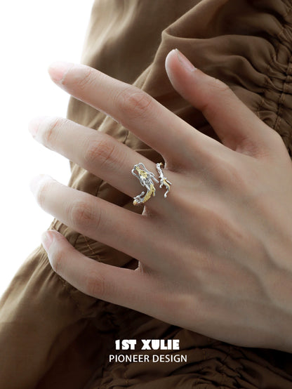 Gold dragon wrap silver ring on a model's hand, showcasing a unique and elegant design
